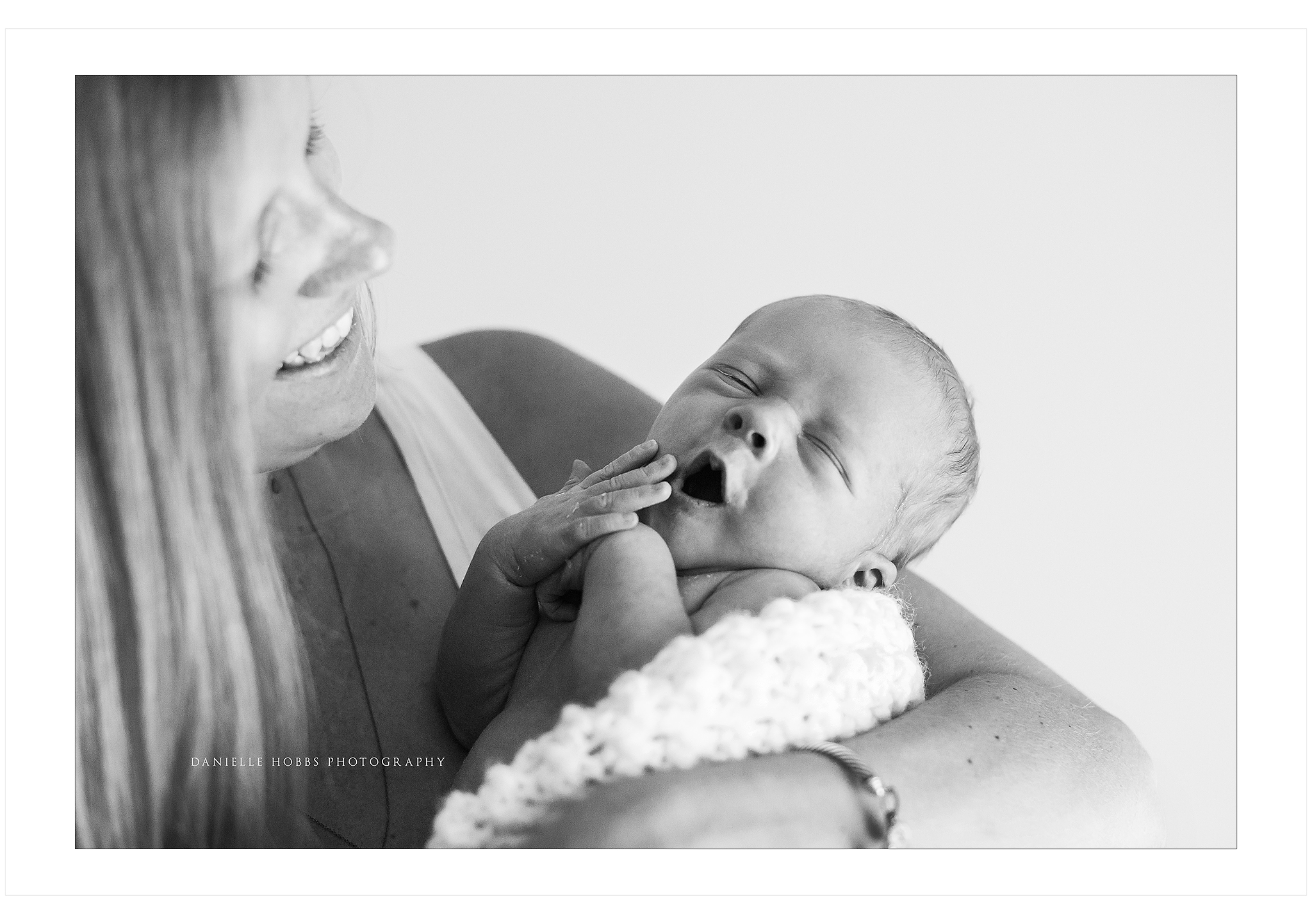 Mom holding yawning baby Reston VA