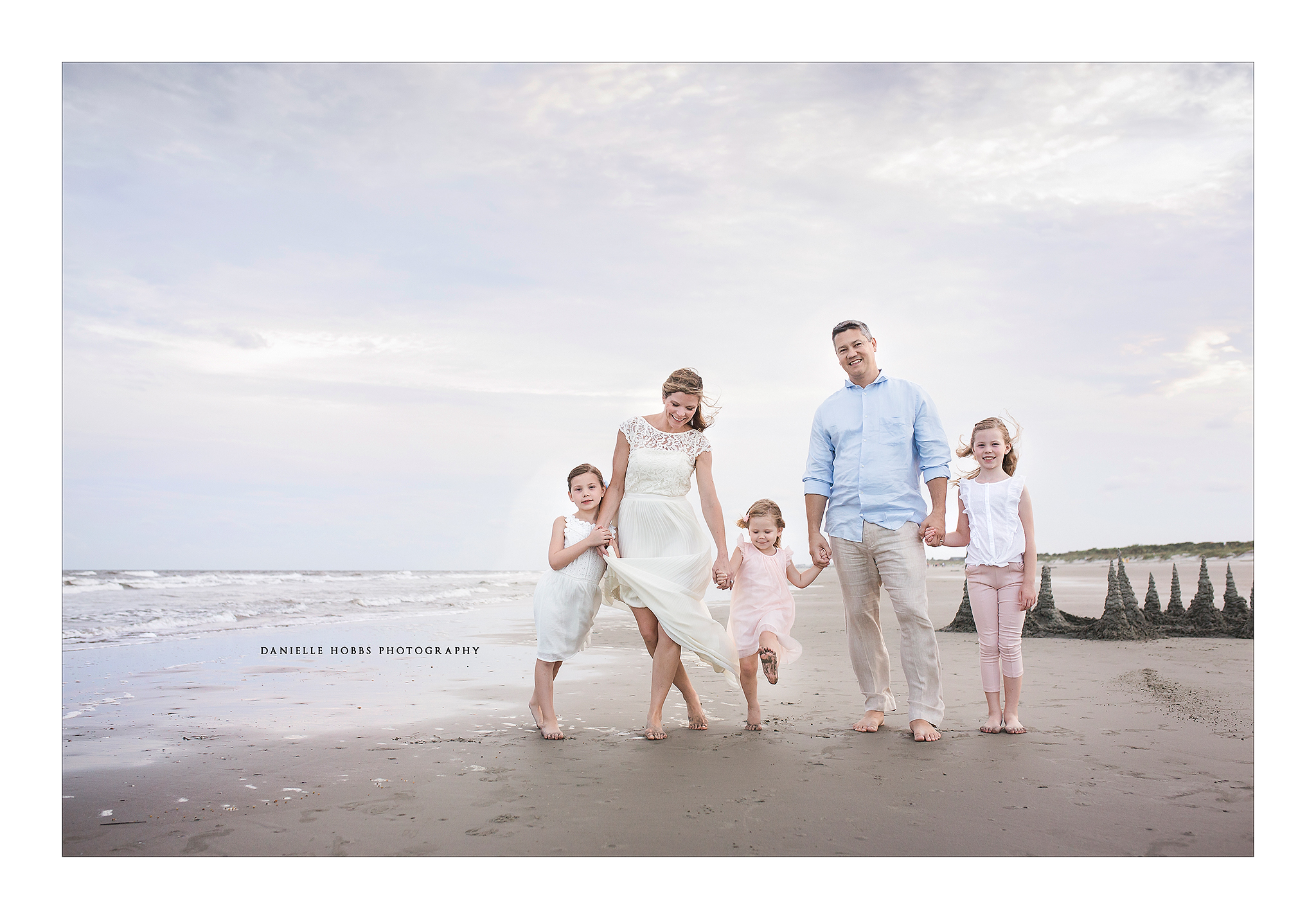 Family on the beach at sunset in neutral wardrobe