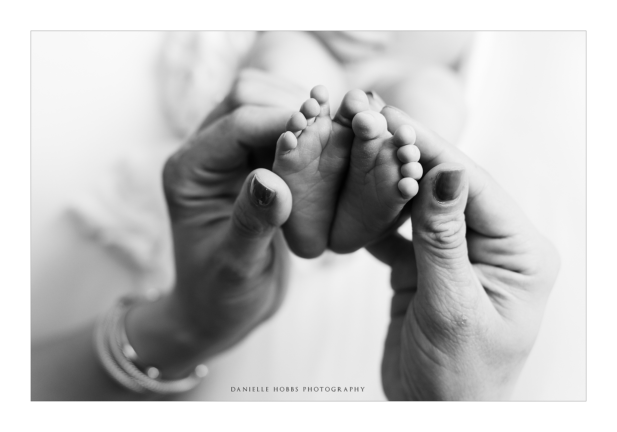 baby feet in mother's hands