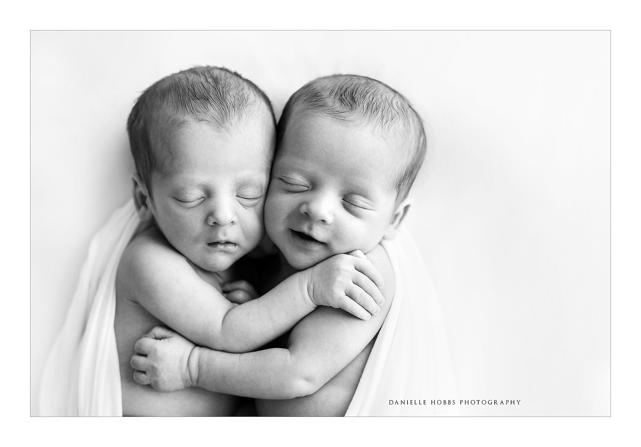 Newborn Twins hugging