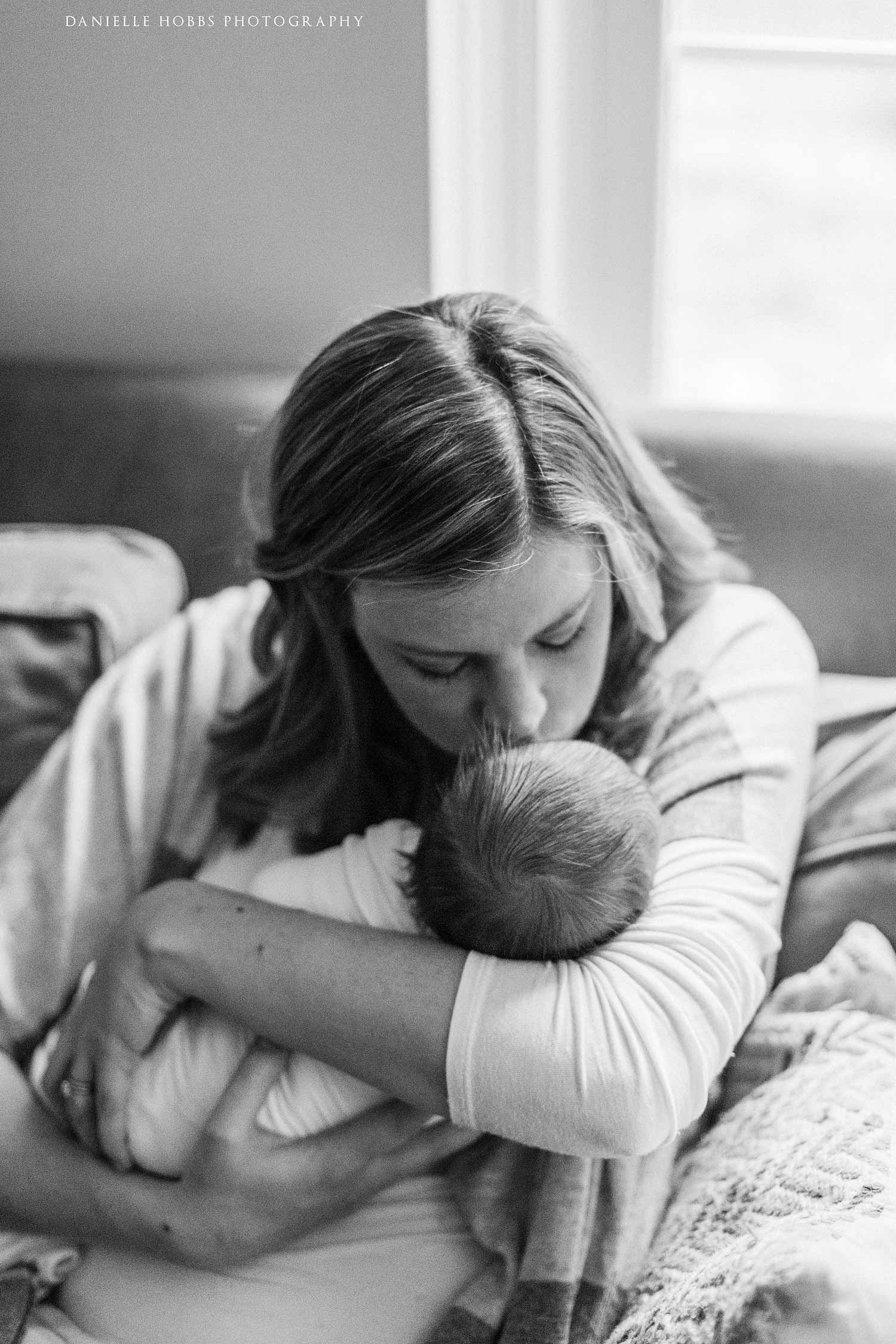 mom kissing baby black and white photo washington dc newborn photography