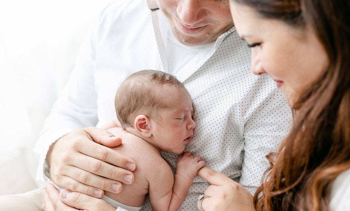 Parents cuddling baby Washington DC Newborn Portraits