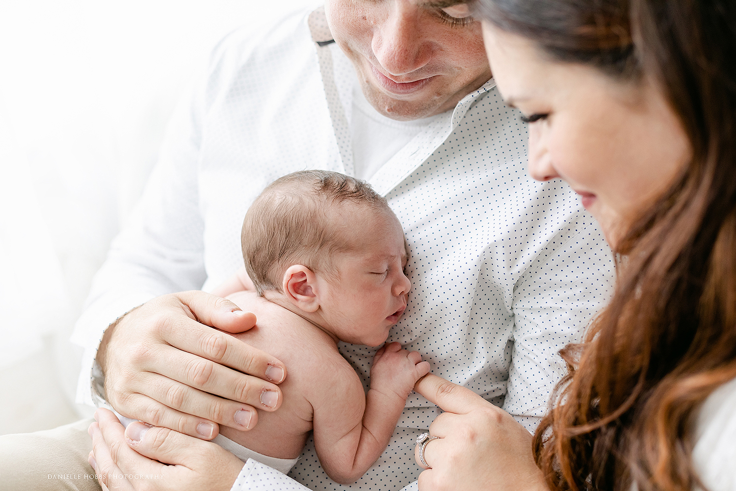 Parents cuddling baby Washington DC Newborn Portraits